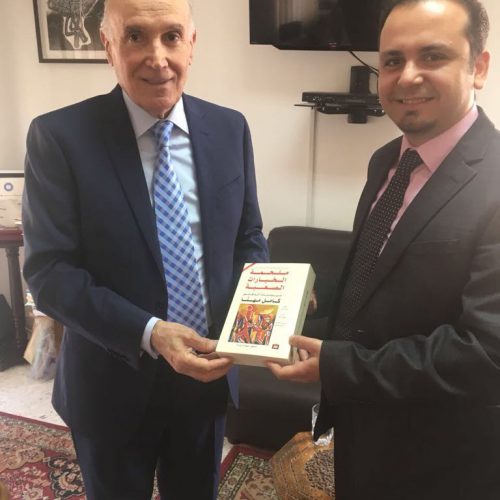 President of , Amel Association International , Dr. Kamel Mhanna, Presents a Book to Dr. Hassan Tajideen